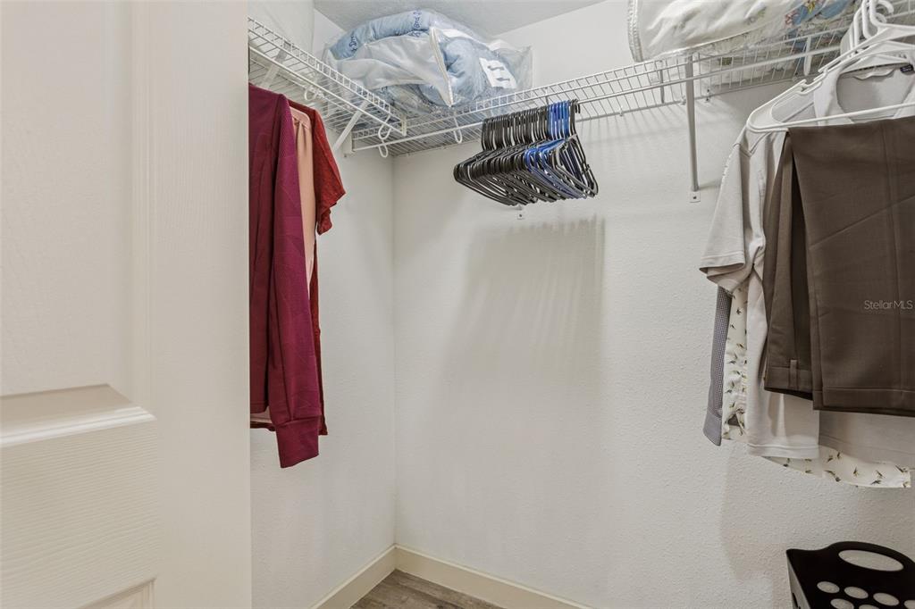1231 Godavari Way, Unit 101 Wesley Chapel, FL 33543 - Photo 22 of 36 a view of walk in closet with clothes and shoes