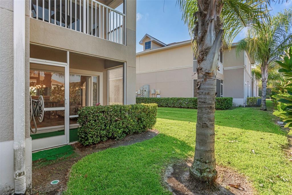 1231 Godavari Way, Unit 101 Wesley Chapel, FL 33543 - Photo 25 of 36 a view of a house with a yard and plants