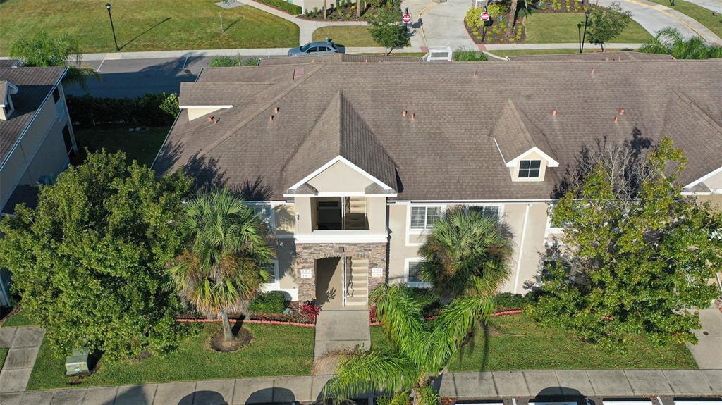 1231 Godavari Way, Unit 101 Wesley Chapel, FL 33543 - Photo 36 of 36 an aerial view of a house with a yard and plants