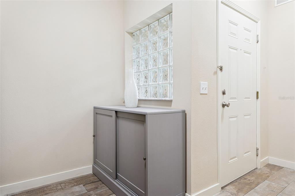 1231 Godavari Way, Unit 101 Wesley Chapel, FL 33543 - Photo 5 of 36 a view of an empty room with wooden floor and a window