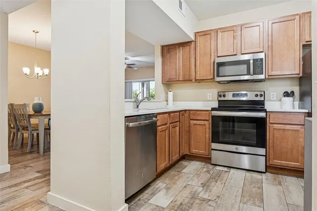 a kitchen with stainless steel appliances granite countertop a stove and a microwave