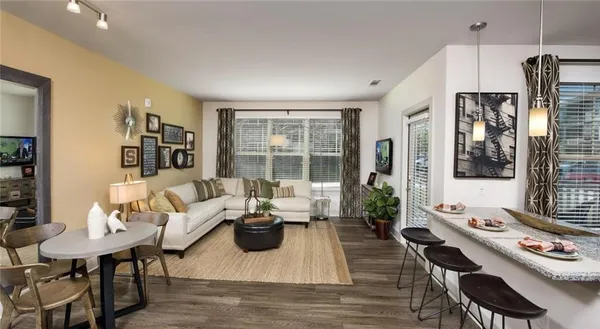 a living room with furniture fireplace and a table