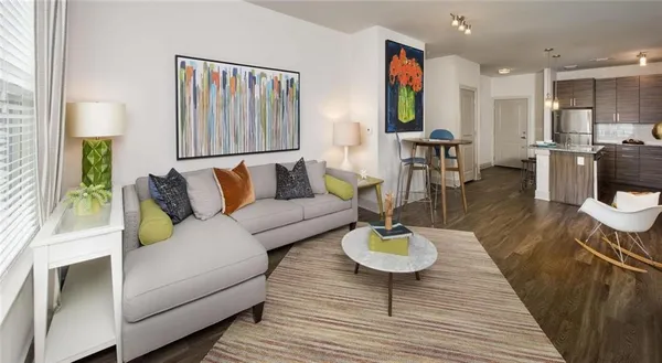 a living room with furniture and wooden floor