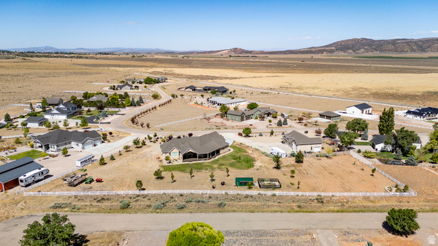 3311 West Allard Summit, UT 84772 - Photo 8 of 97 Expansive rural landscape featuring scattered residential properties, paved and unpaved roads, and distant mountains under a clear sky