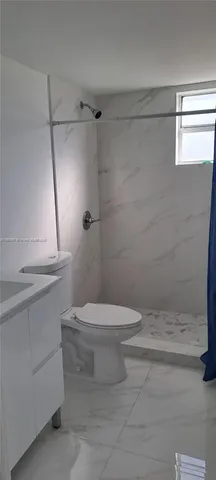 a view of a small space with wooden floor and a window