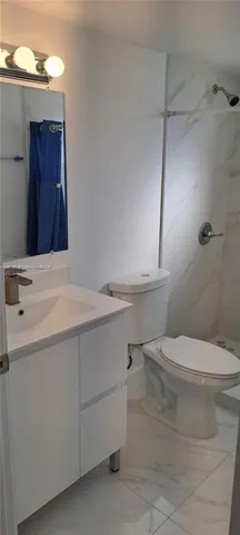 a bathroom with a shower and a toilet
