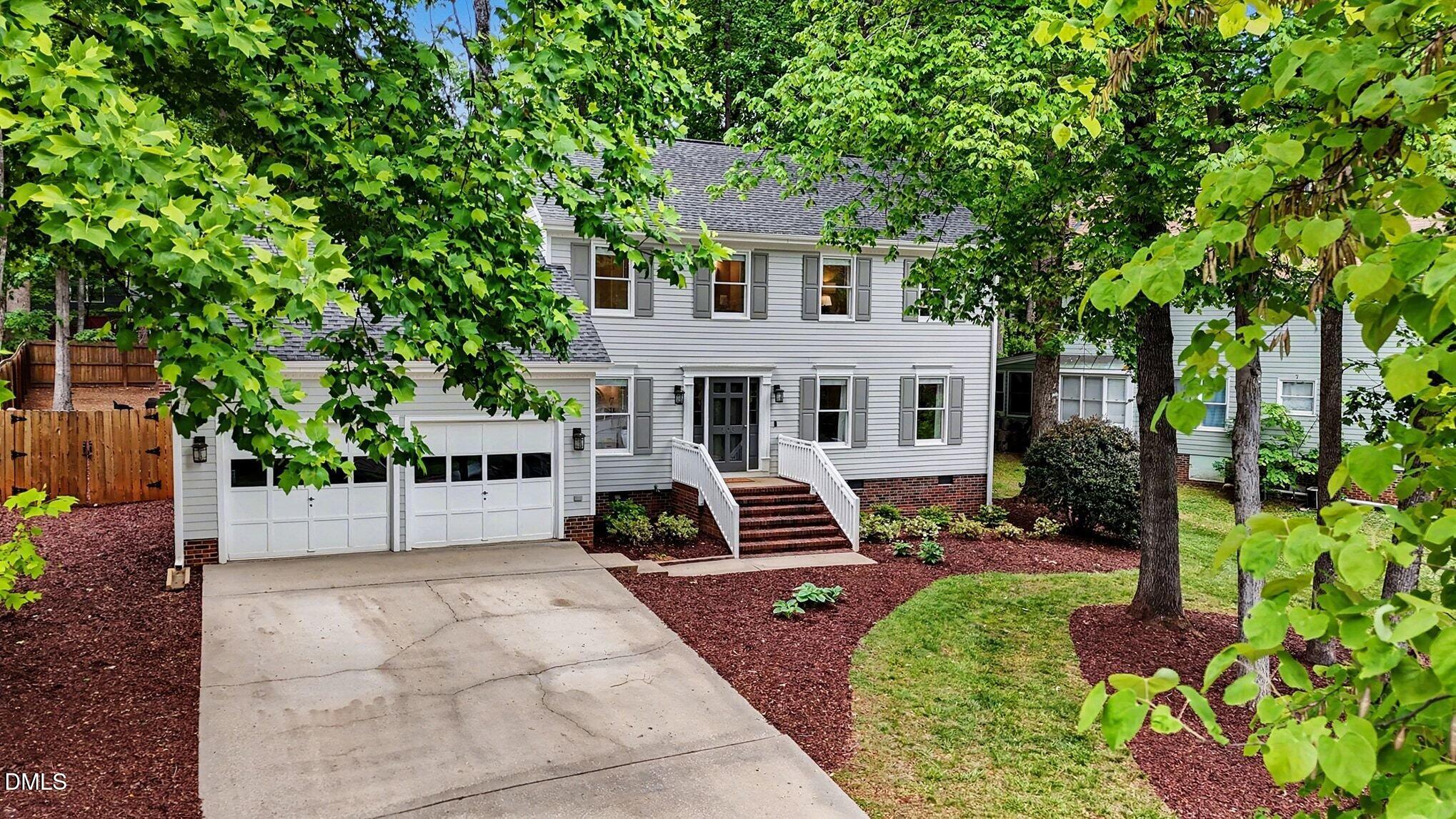 103 Leckford Way Cary, NC 27513 - Photo 1 of 49 a front view of a house with a yard and potted plants