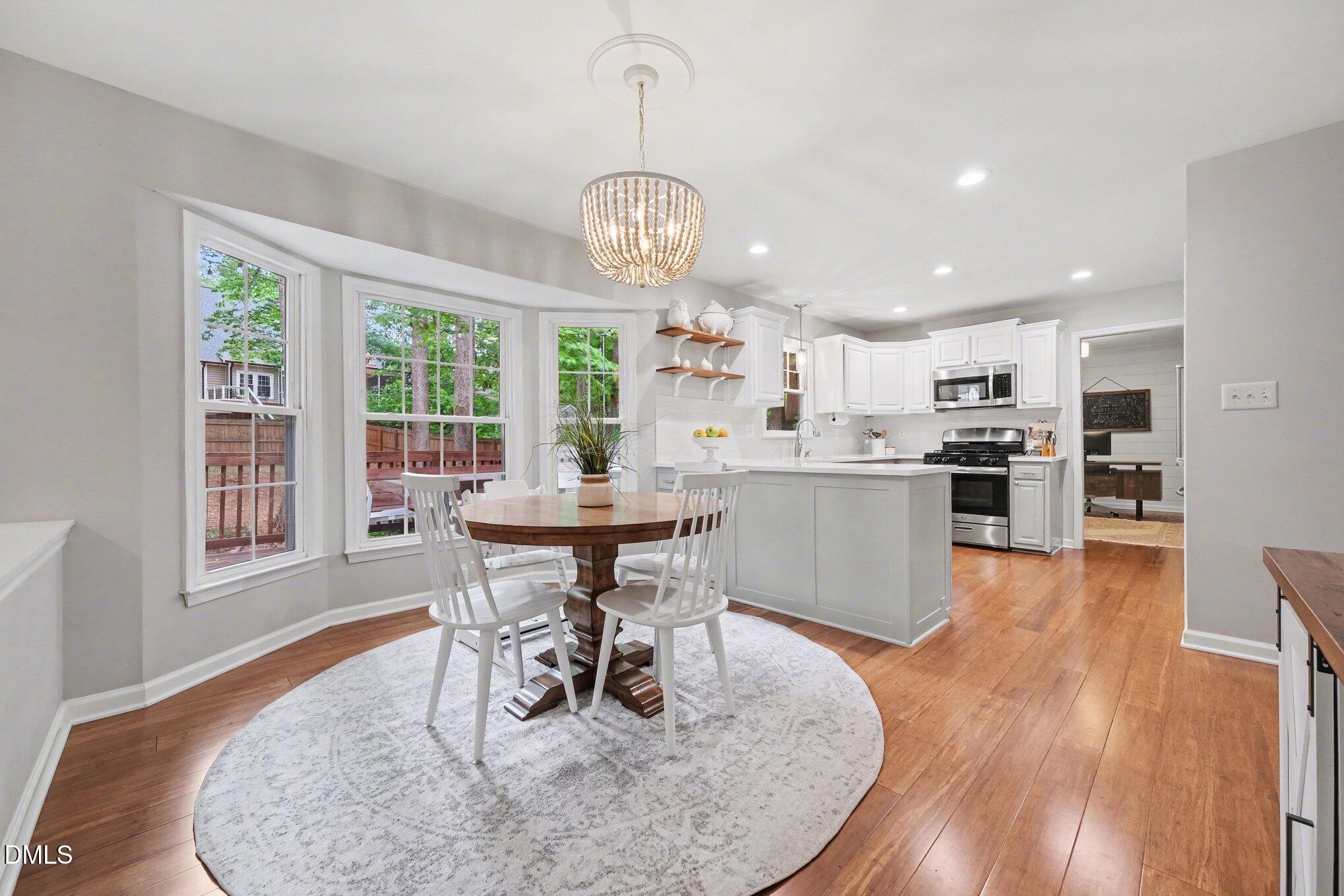 103 Leckford Way Cary, NC 27513 - Photo 17 of 49 a view of a dining room with furniture window and wooden floor