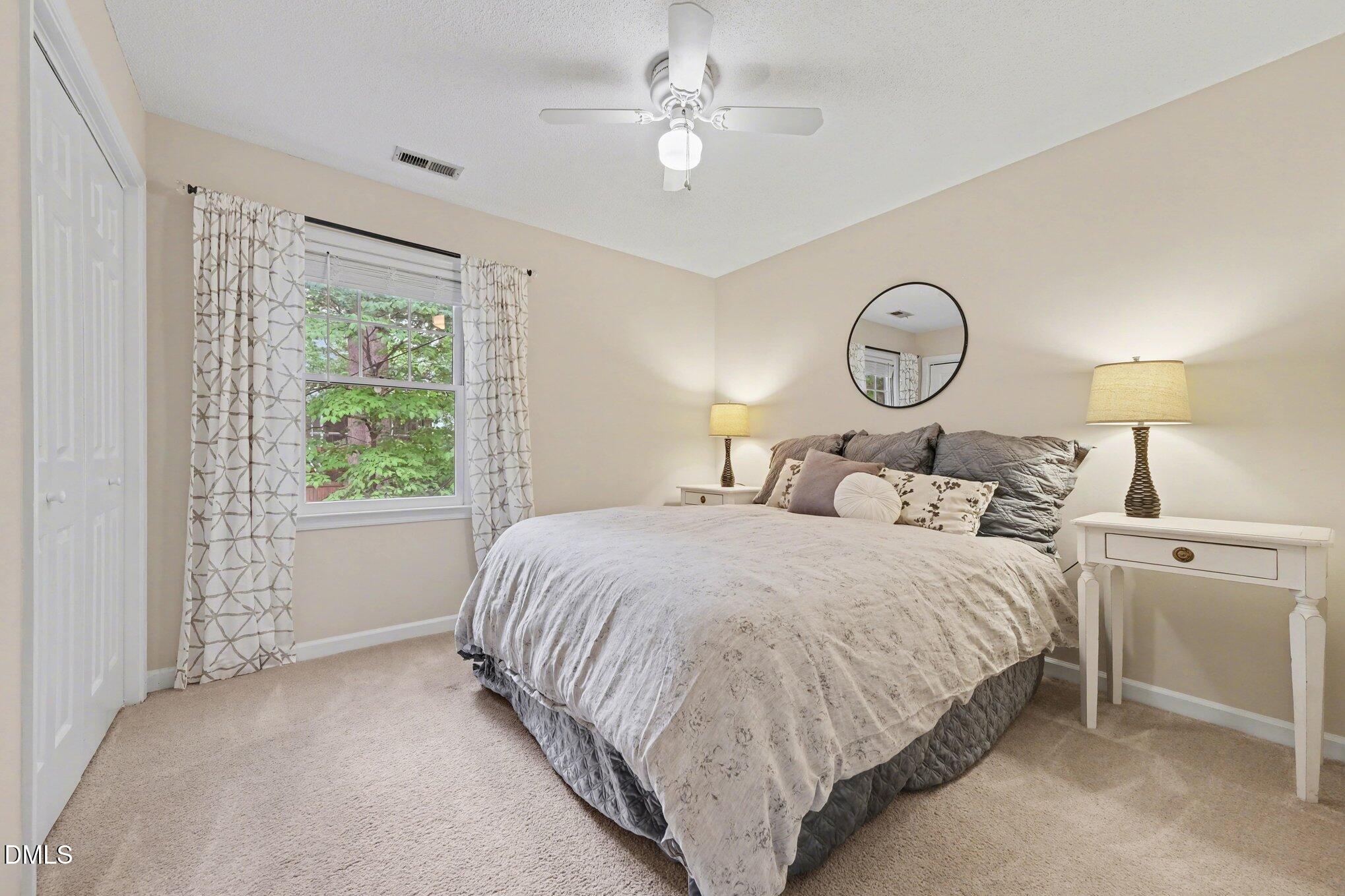103 Leckford Way Cary, NC 27513 - Photo 21 of 49 a bedroom with a bed and a chandelier