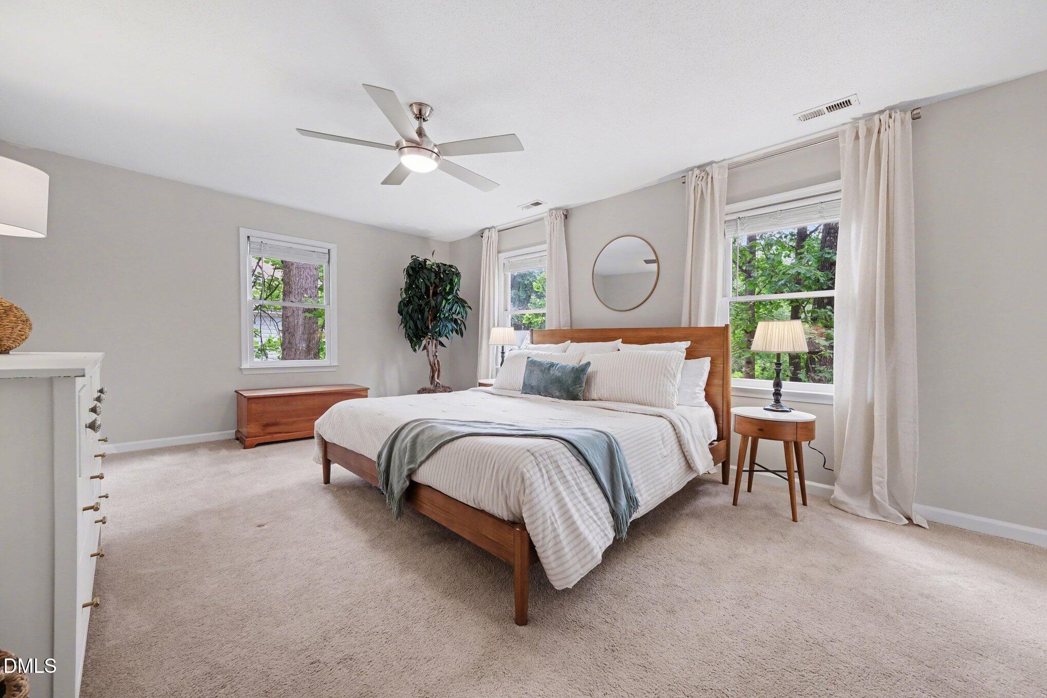 103 Leckford Way Cary, NC 27513 - Photo 22 of 49 a bed sitting in a spacious bedroom next to a window