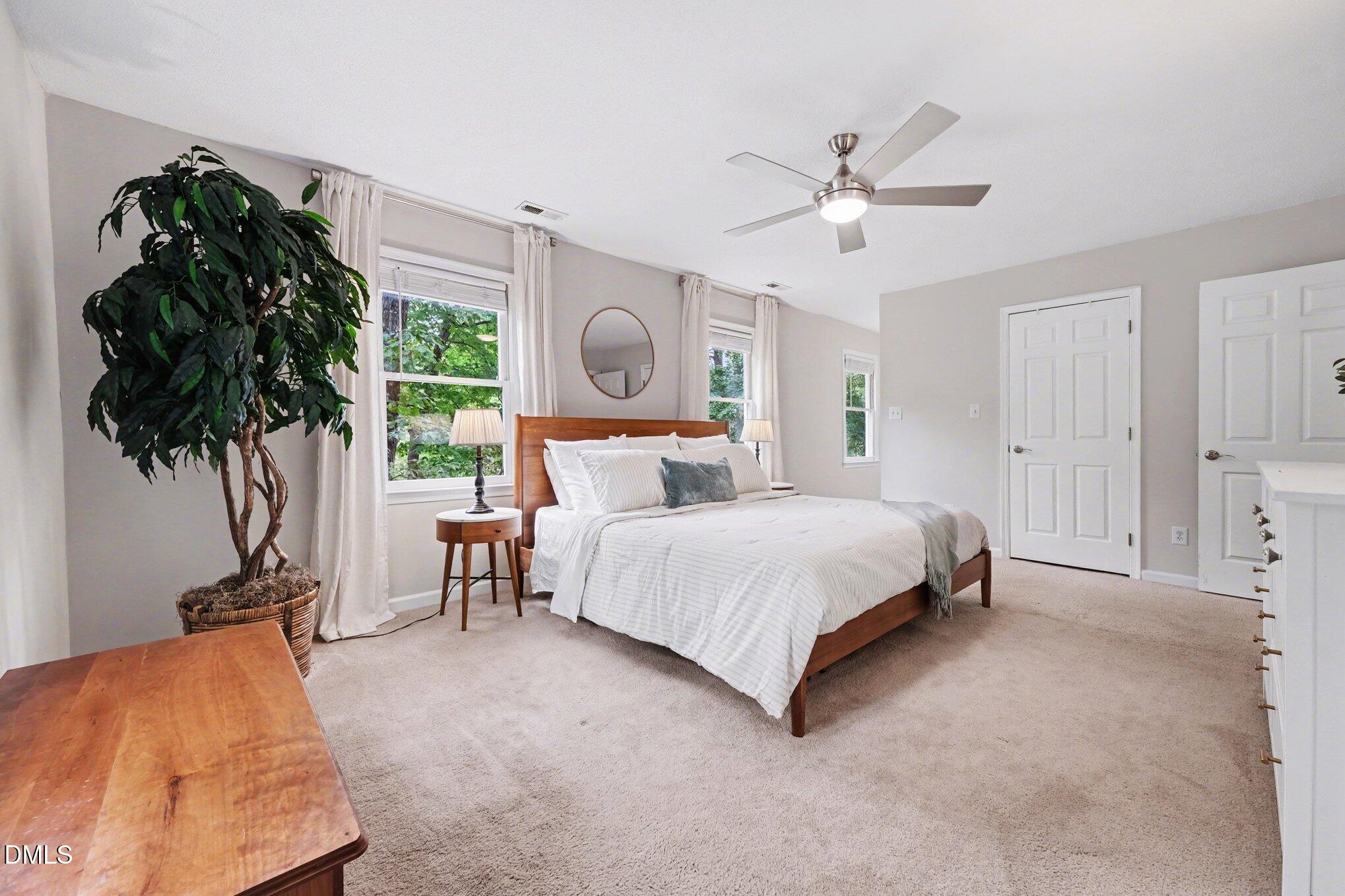 103 Leckford Way Cary, NC 27513 - Photo 23 of 49 a bed room with a bed and a potted plant