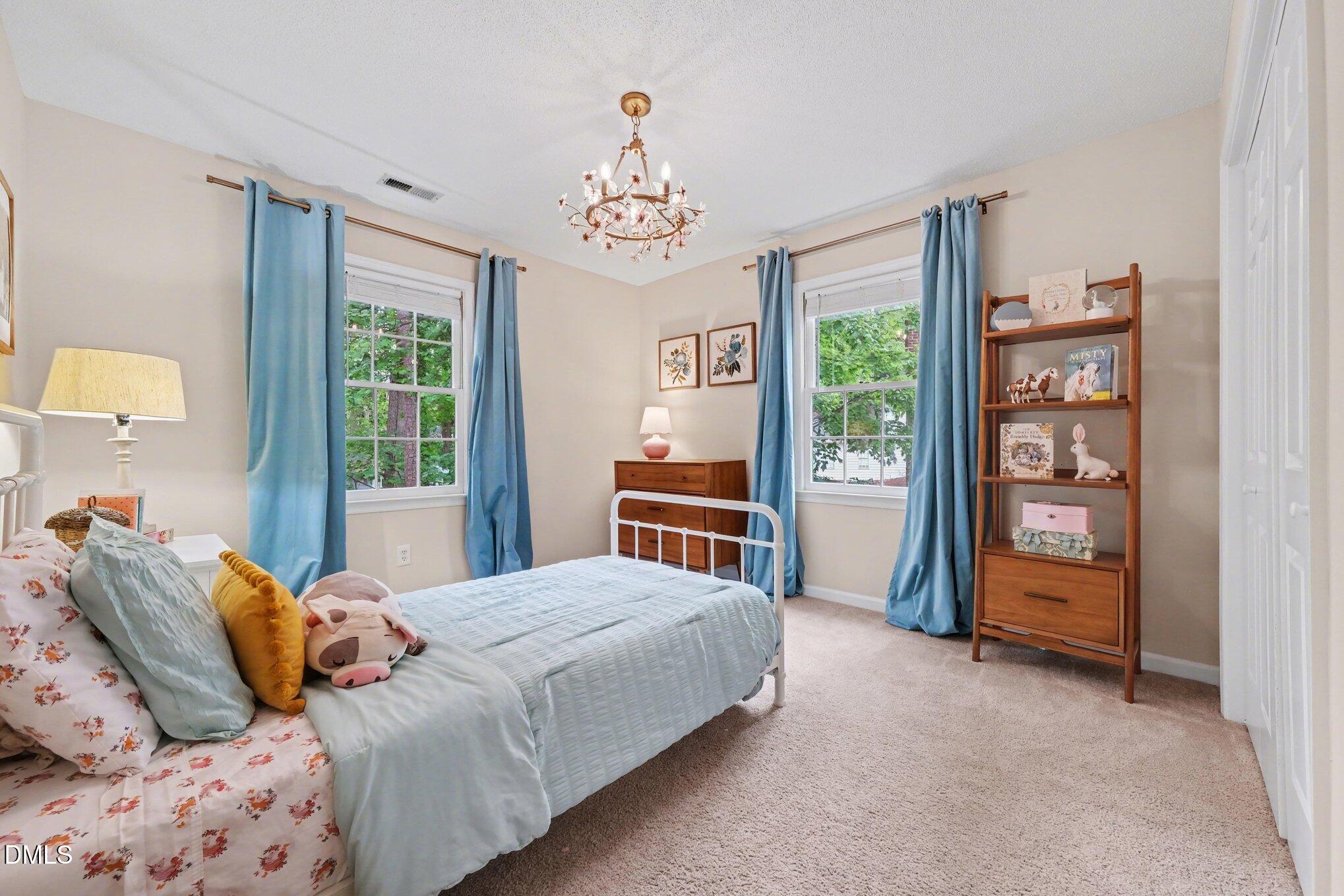 103 Leckford Way Cary, NC 27513 - Photo 25 of 49 a bedroom with a large bed and a window