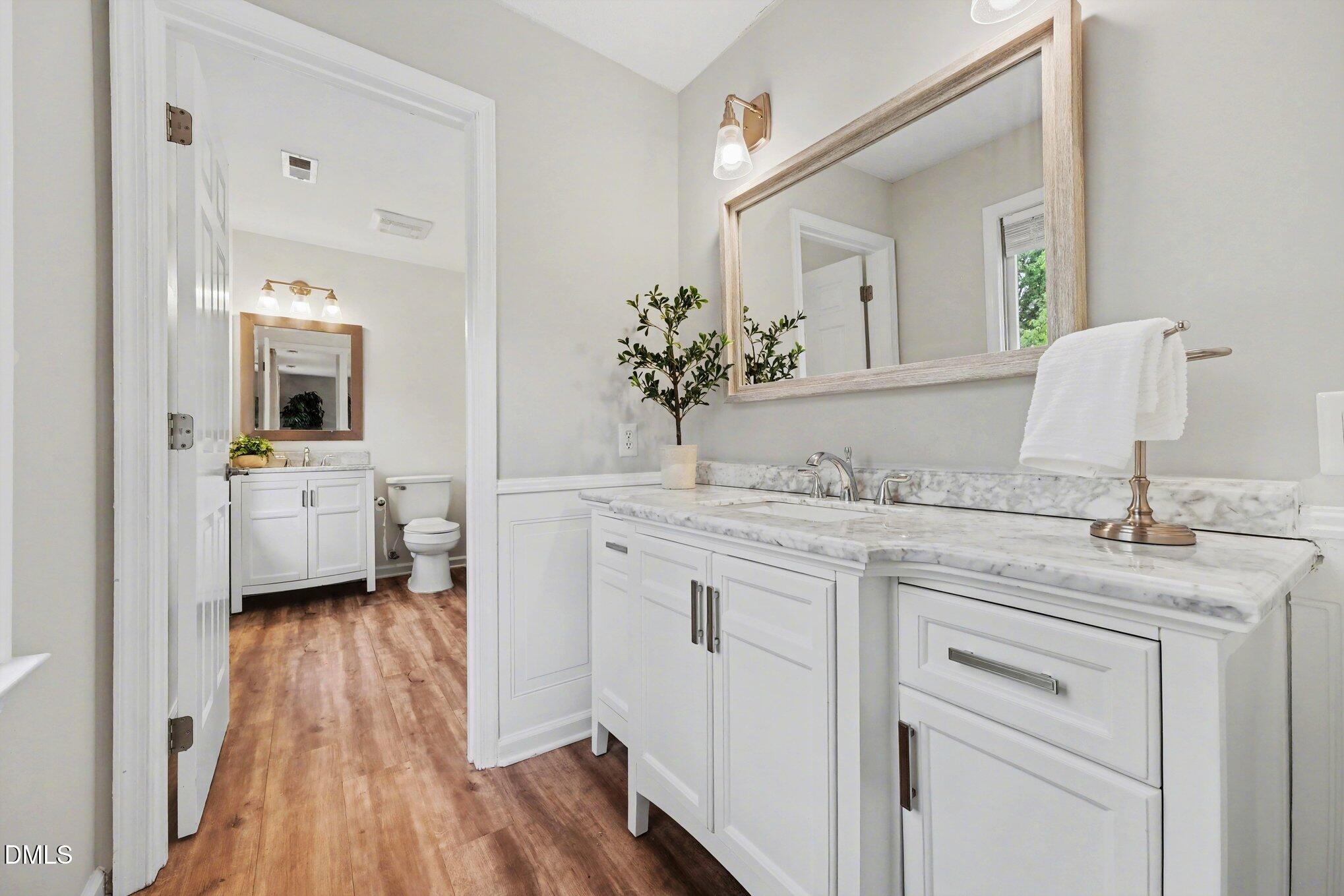 103 Leckford Way Cary, NC 27513 - Photo 27 of 49 a en suite bathroom with a granite countertop sink and a mirror