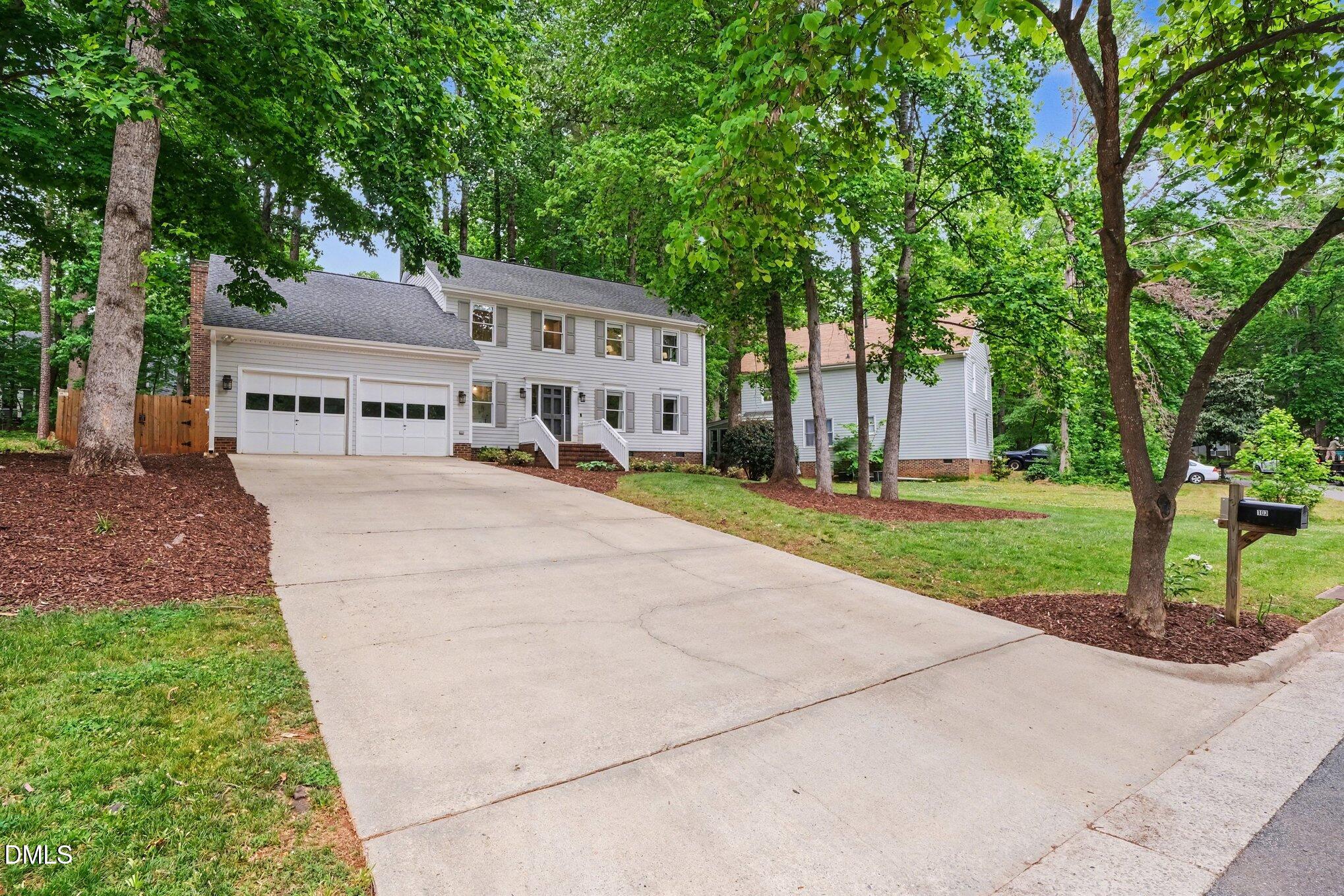 103 Leckford Way Cary, NC 27513 - Photo 3 of 49 a view of house with yard and trees