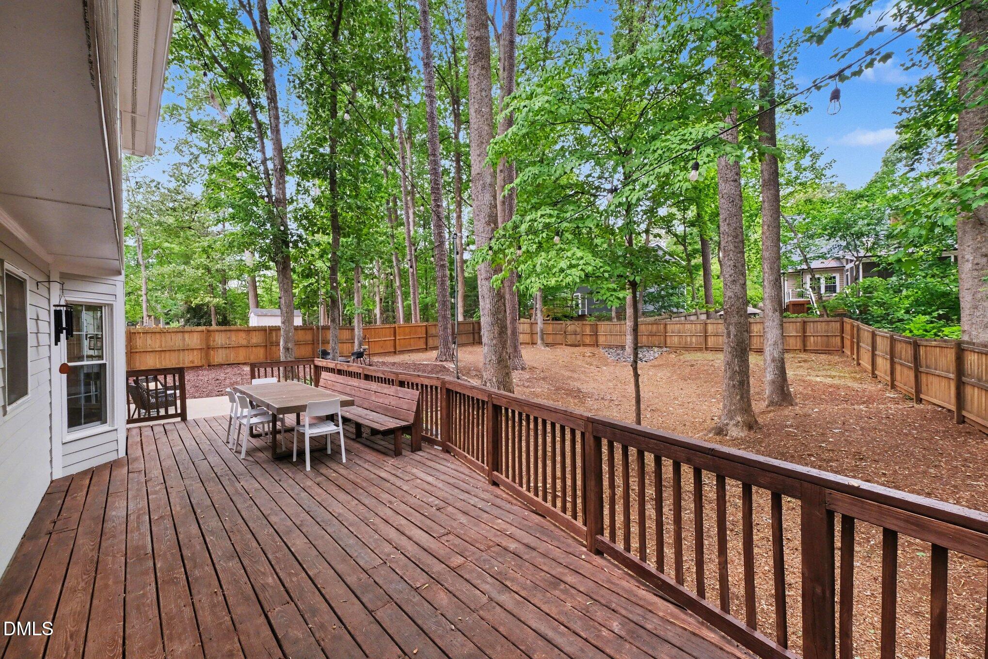 103 Leckford Way Cary, NC 27513 - Photo 34 of 49 a view of a roof deck with table and chairs and wooden floor