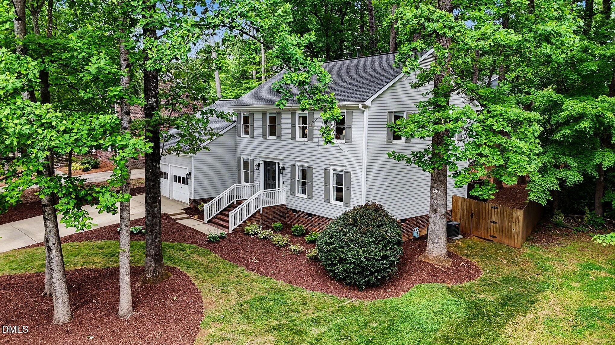 103 Leckford Way Cary, NC 27513 - Photo 39 of 49 a front view of a house with a yard and potted plants