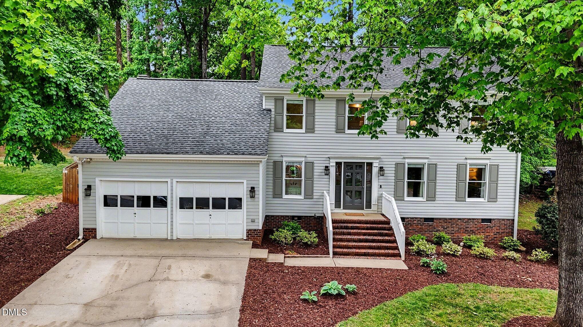 103 Leckford Way Cary, NC 27513 - Photo 40 of 49 a front view of a house with garden