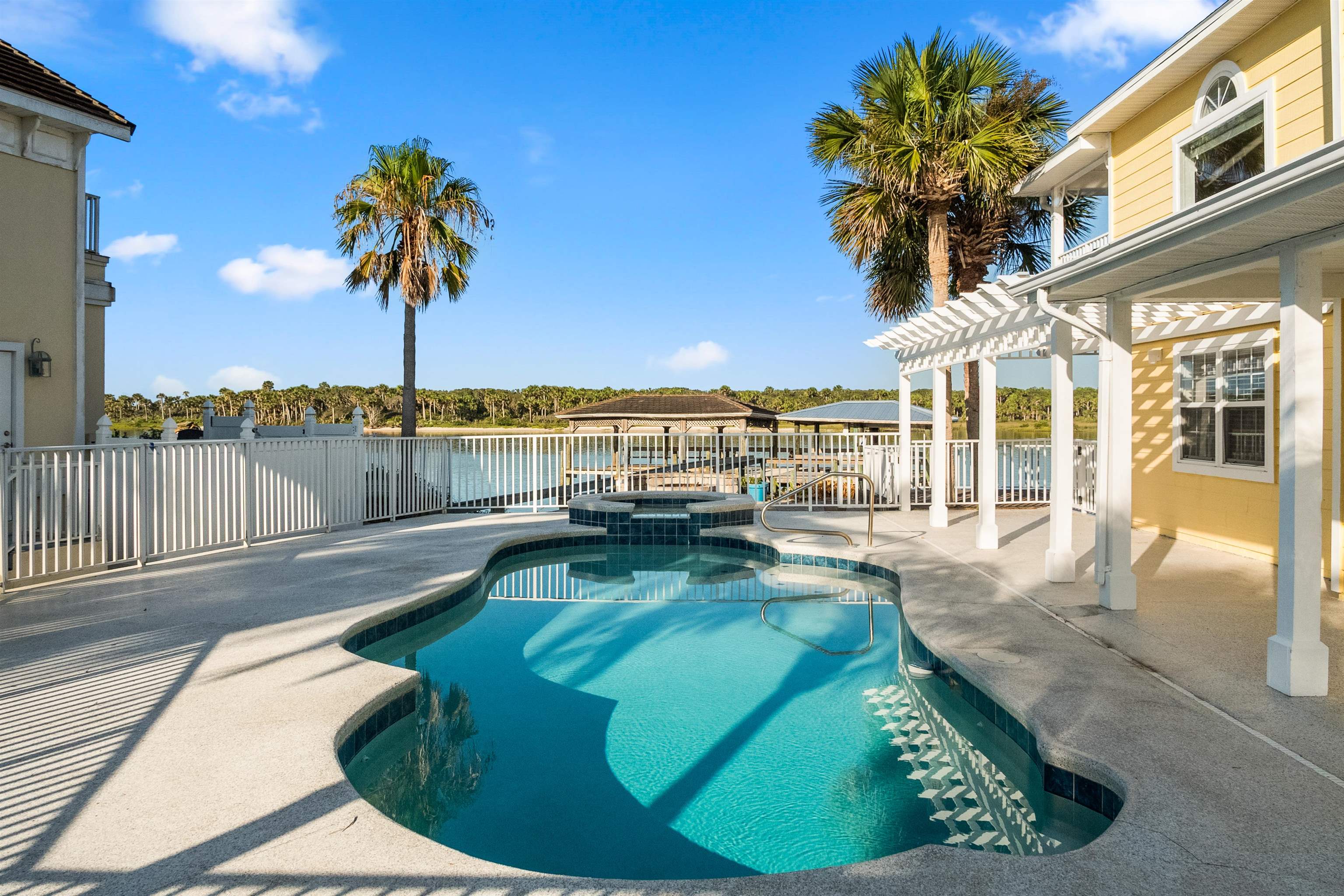 9277 July Lane St. Augustine, FL 32080 - Photo 20 of 72 a view of a swimming pool with a table and chairs