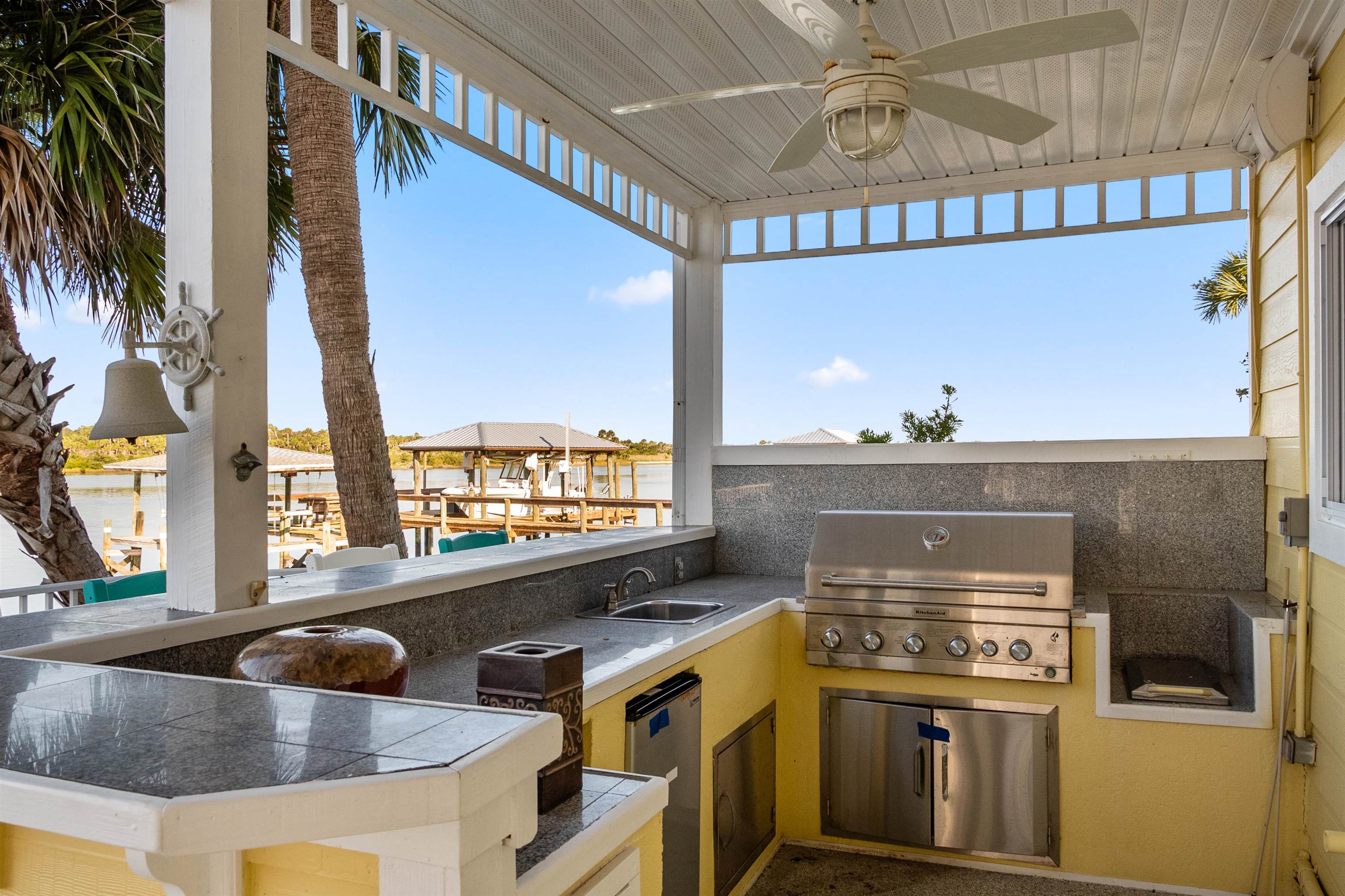 9277 July Lane St. Augustine, FL 32080 - Photo 24 of 72 a kitchen with a stove two sinks and a refrigerator