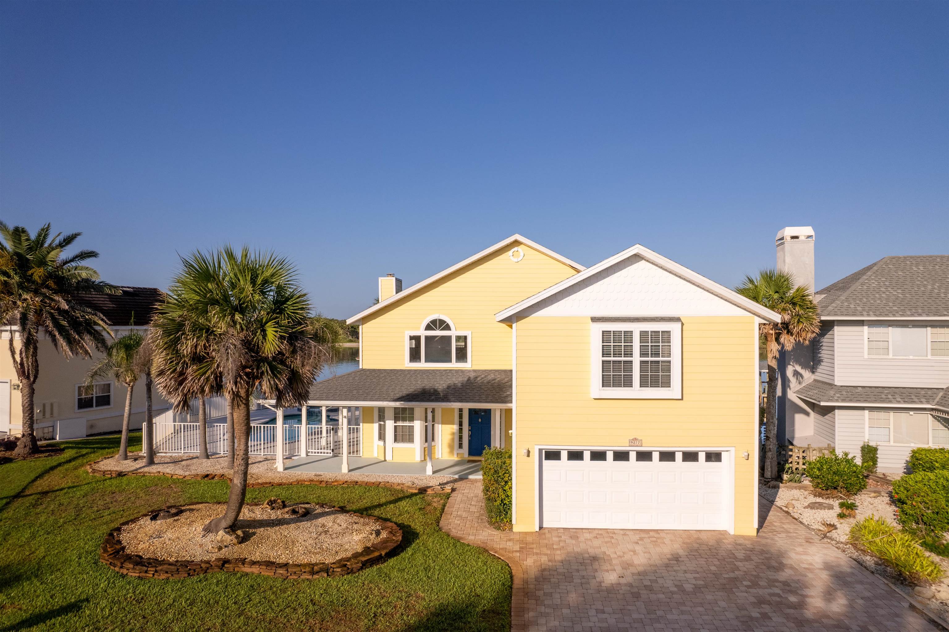 9277 July Lane St. Augustine, FL 32080 - Photo 4 of 72 a front view of a house with a yard and garage