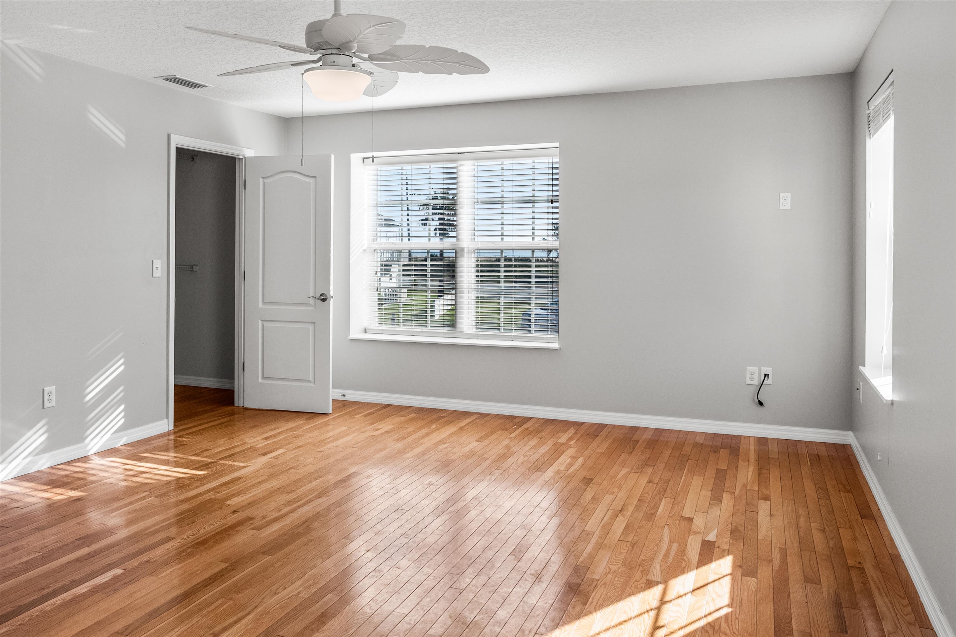 9277 July Lane St. Augustine, FL 32080 - Photo 47 of 72 a view of an empty room with wooden floor and a window