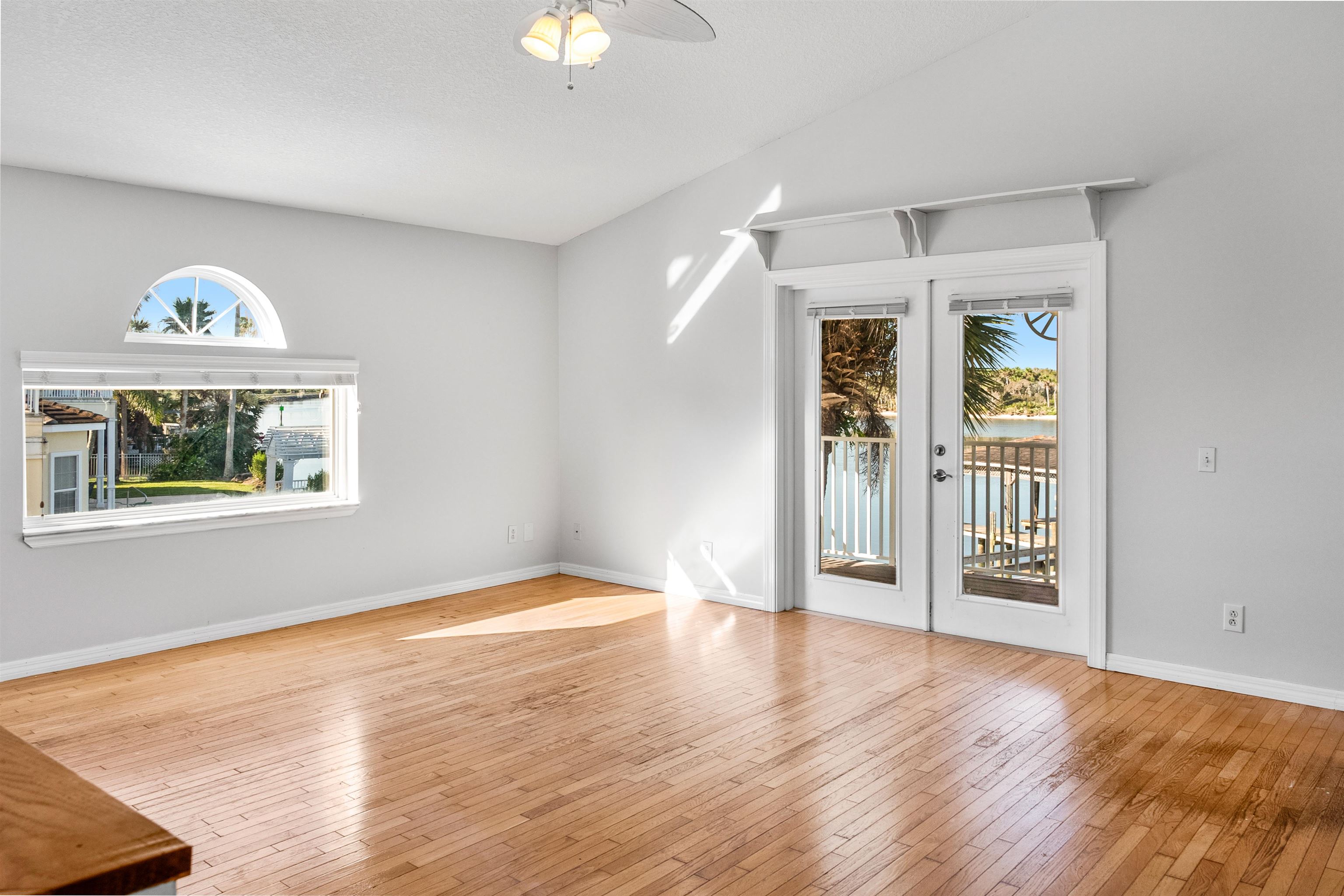 9277 July Lane St. Augustine, FL 32080 - Photo 49 of 72 a view of an empty room with a window and wooden floor