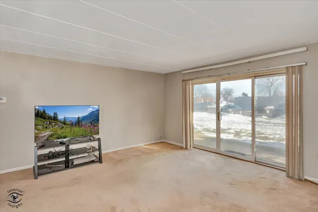 a room with furniture and a floor to ceiling window