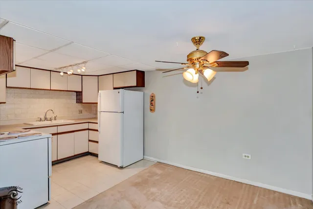 a kitchen with stainless steel appliances granite countertop cabinets a sink a window and a refrigerator