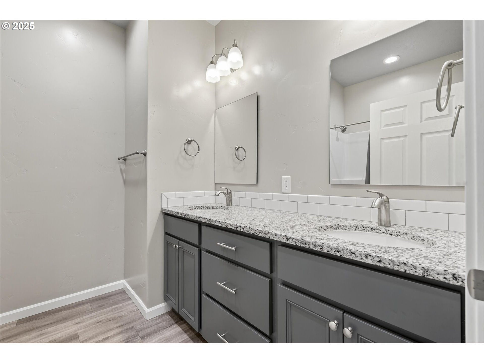 565 Baker Street Baker City, OR 97814 - Photo 26 of 36 a bathroom with a granite countertop sink and a mirror