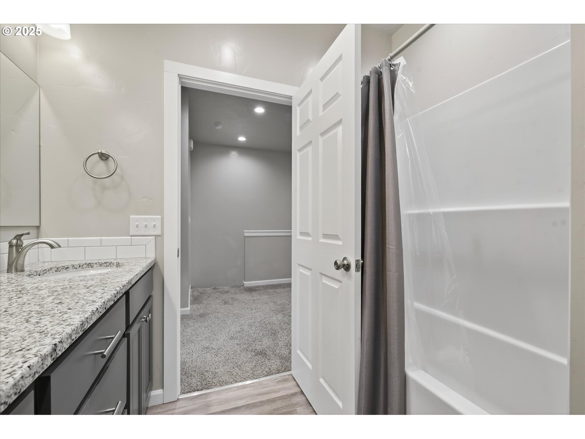565 Baker Street Baker City, OR 97814 - Photo 27 of 36 a bathroom with a granite countertop sink a mirror and shower