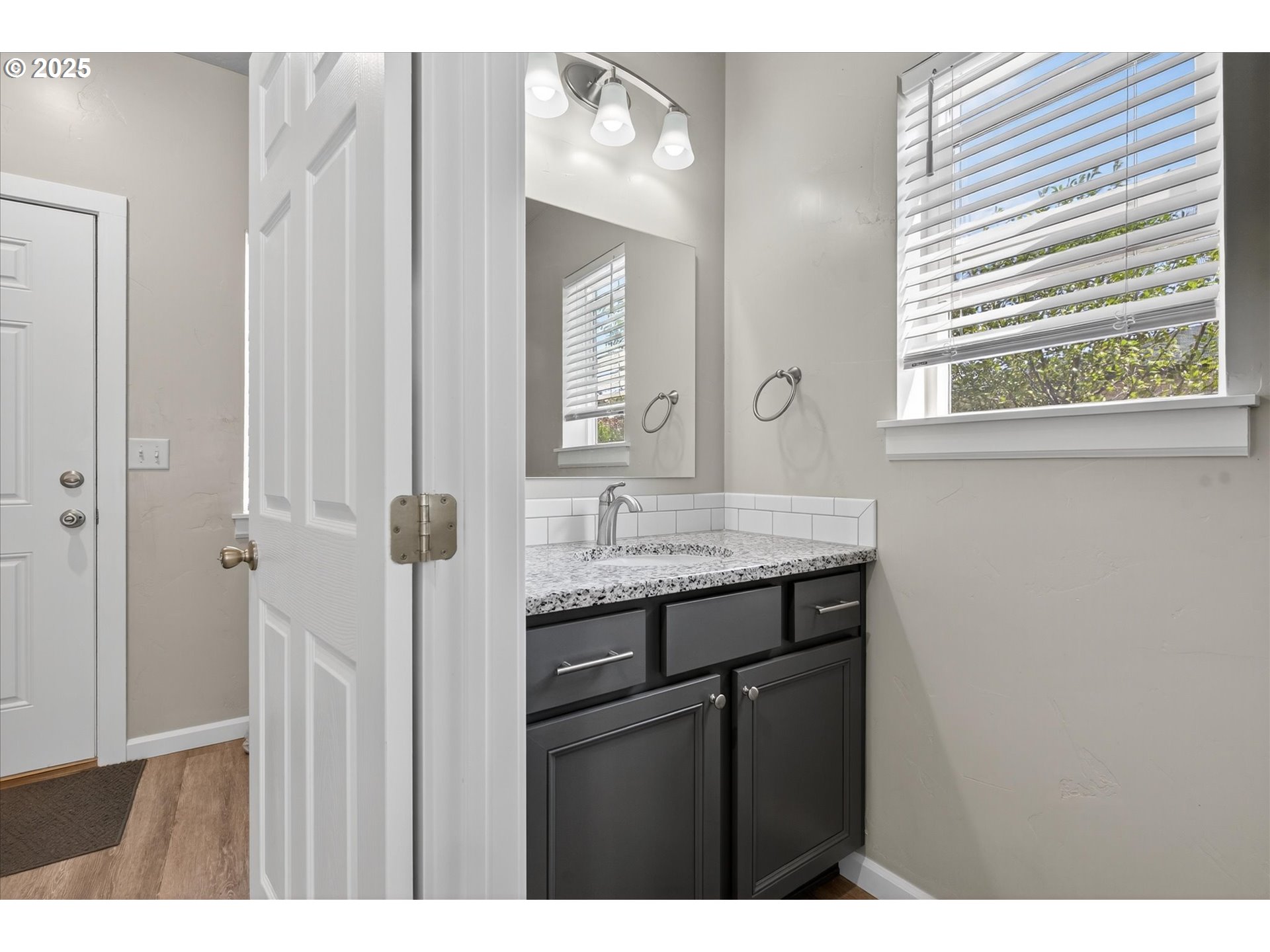 565 Baker Street Baker City, OR 97814 - Photo 10 of 36 a bathroom with a granite countertop sink and a mirror