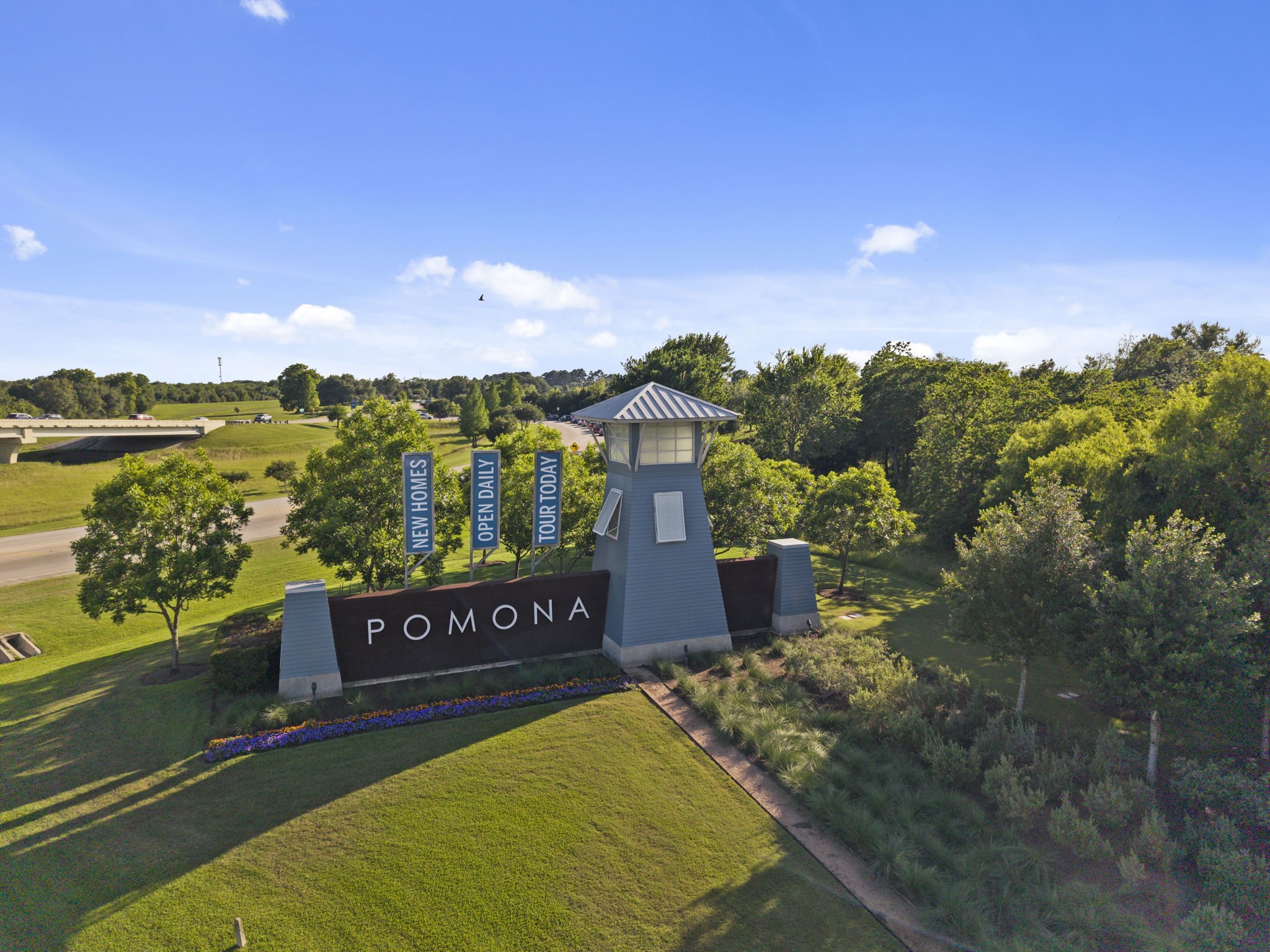2119 Blackhawk Ridge Lane Manvel, TX 77578 - Photo 46 of 49 Welcome home! Pomona's grand community entrance off Hwy 288 greets residents and guests with lush landscaping, vibrant seasonal flower beds, and iconic signage — perfectly positioned for easy access to Downtown Houston and the Texas Medical Center.