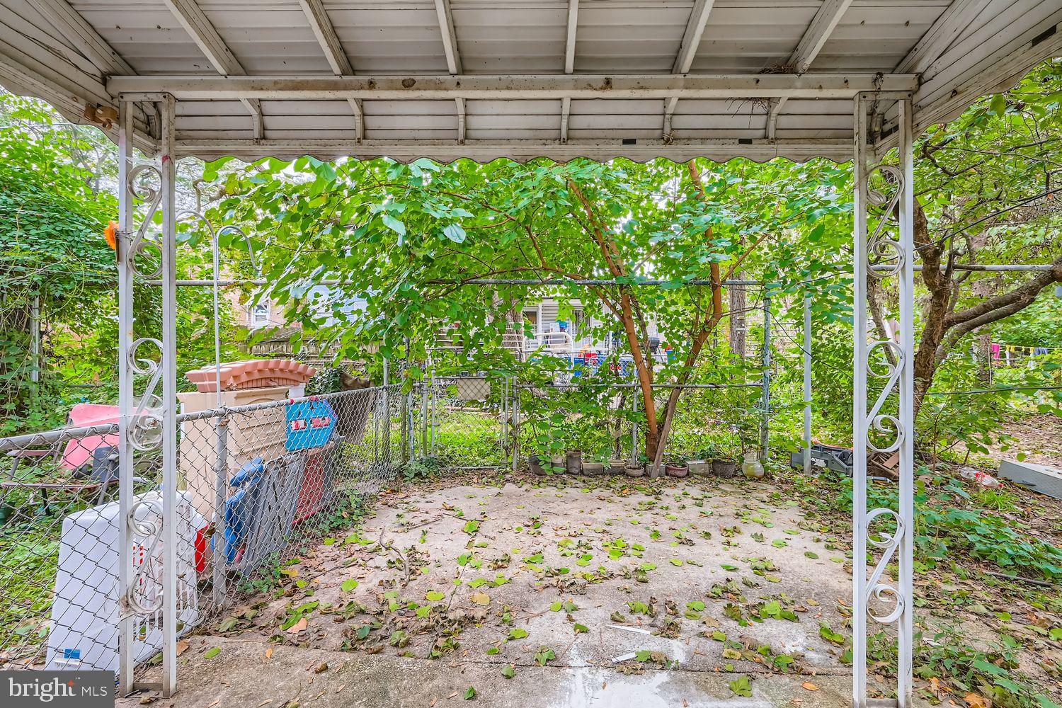415 Cambria Street Baltimore, MD 21225 - Photo 15 of 17 a backyard of a house with lots of green space and seating