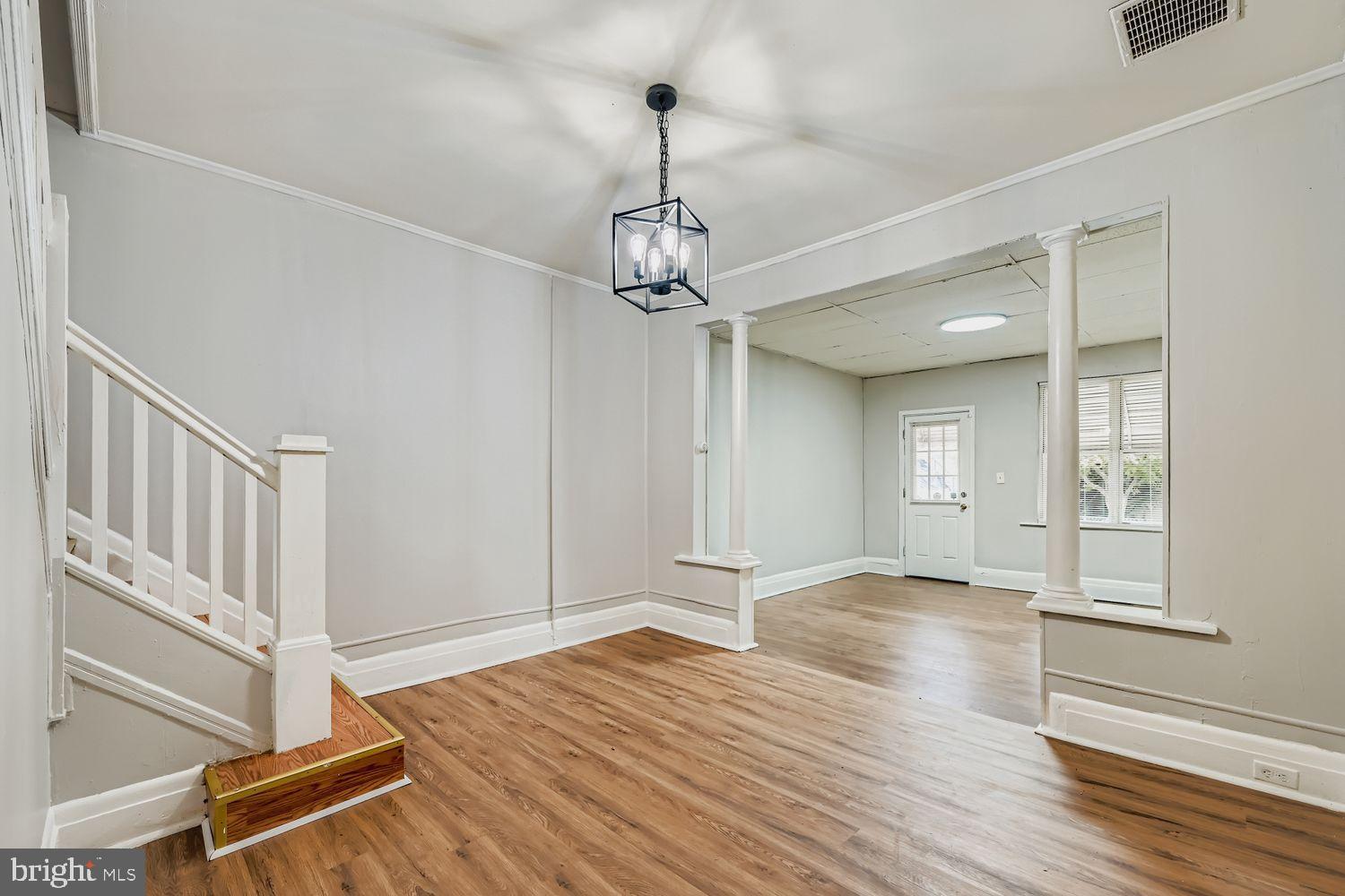 415 Cambria Street Baltimore, MD 21225 - Photo 4 of 17 a view of empty room with wooden floor and fan