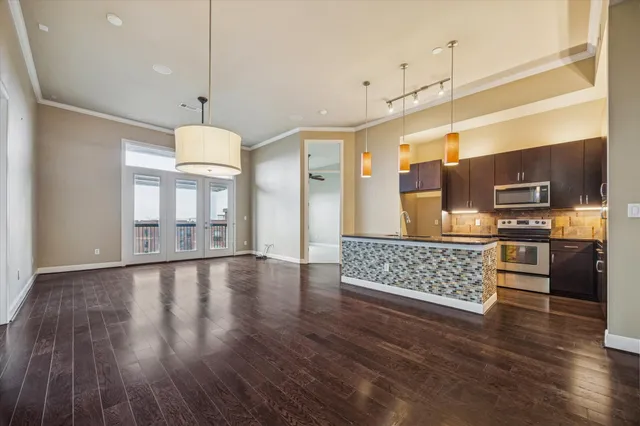 a view of kitchen with sink microwave and refrigerator