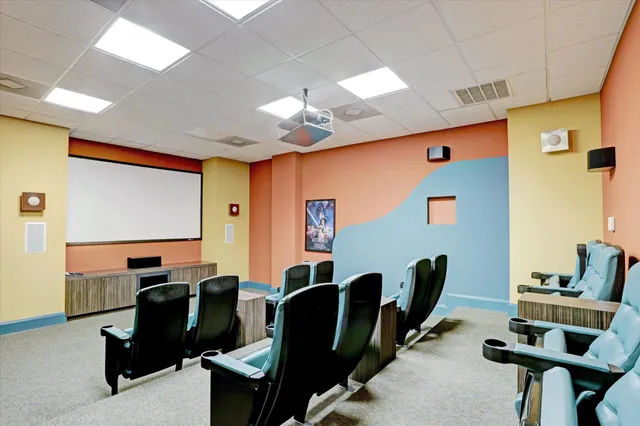 a work room with furniture and a flat screen tv