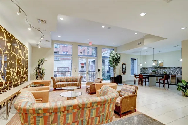 a living room with fireplace furniture and a large window