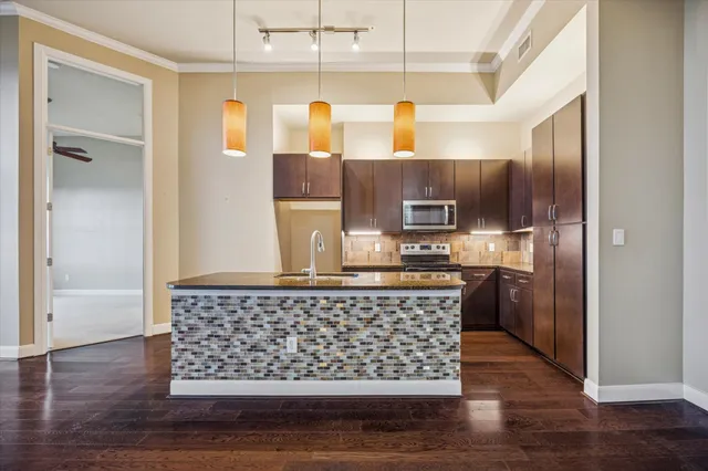 a kitchen with wooden cabinets and stainless steel appliances