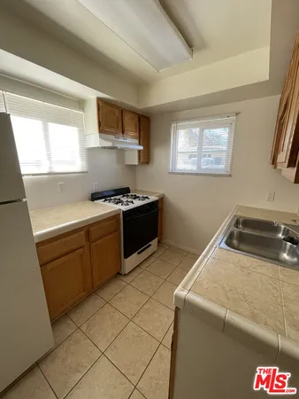 a kitchen that has a sink and a stove