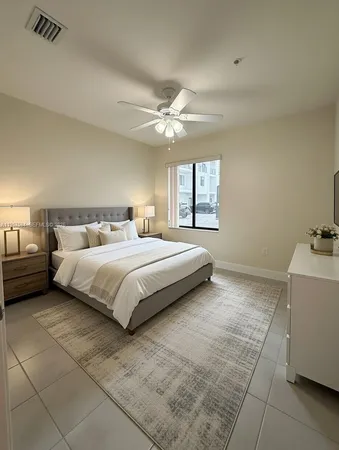 a bedroom with a bed and a ceiling fan