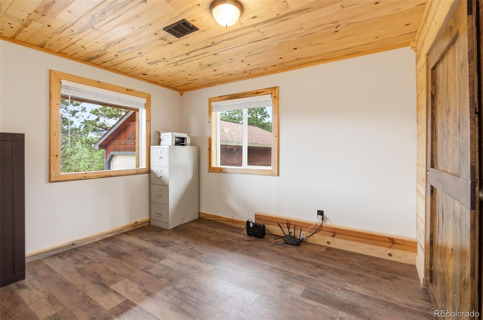 202 Badger Lane Bailey, CO 80421 - Photo 37 of 50 a view of a room with gym equipment and wooden floor