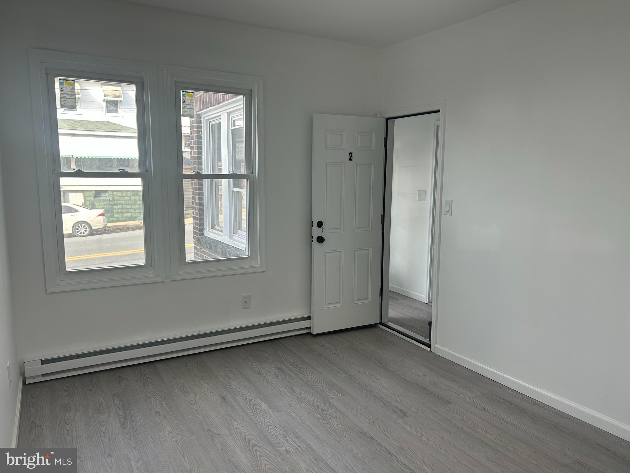 222 West Patterson Street, Unit 2 Lansford, PA 18232 - Photo 2 of 16 an empty room with wooden floor and windows