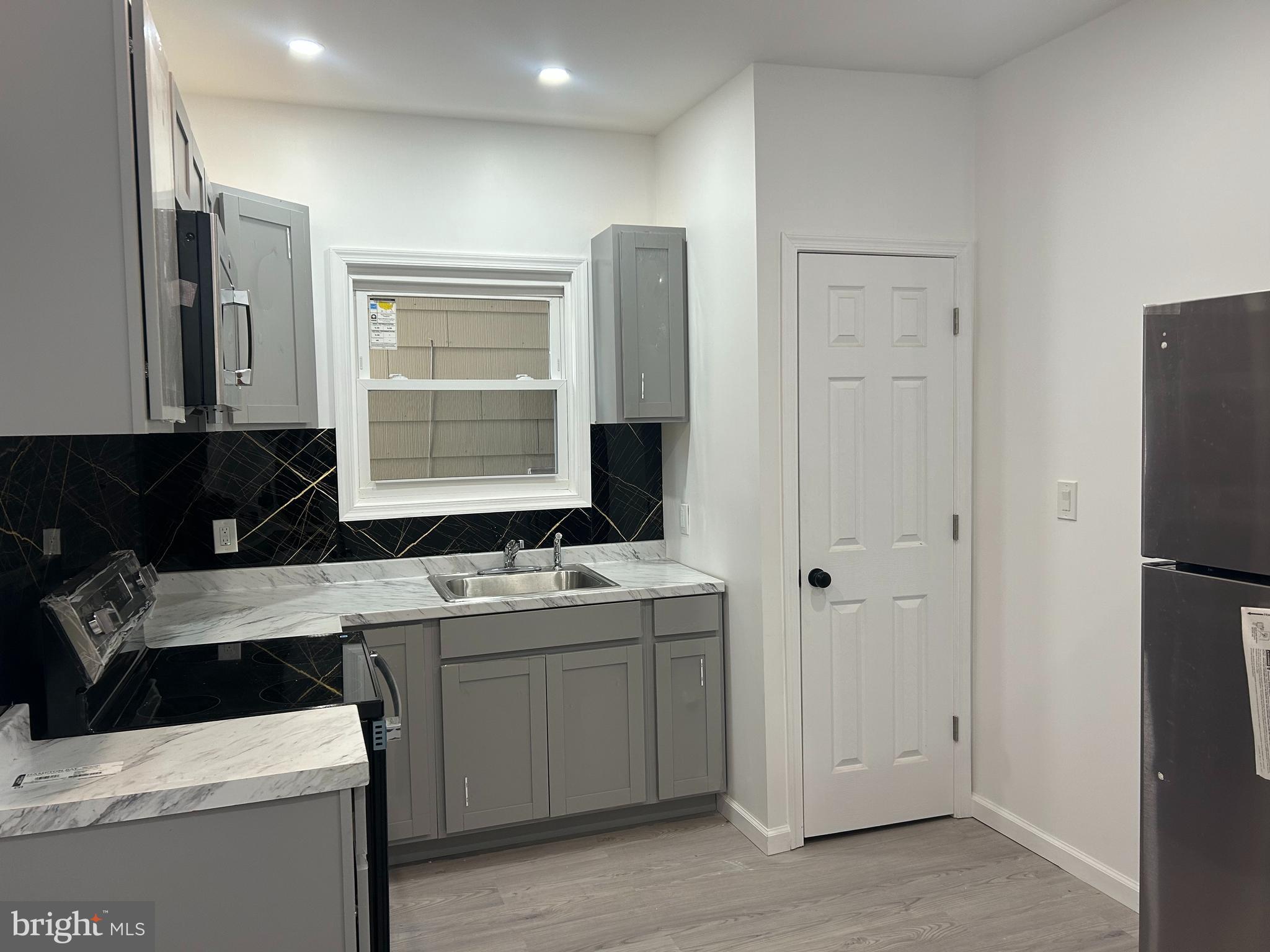 222 West Patterson Street, Unit 2 Lansford, PA 18232 - Photo 8 of 16 a kitchen with a sink stove and refrigerator