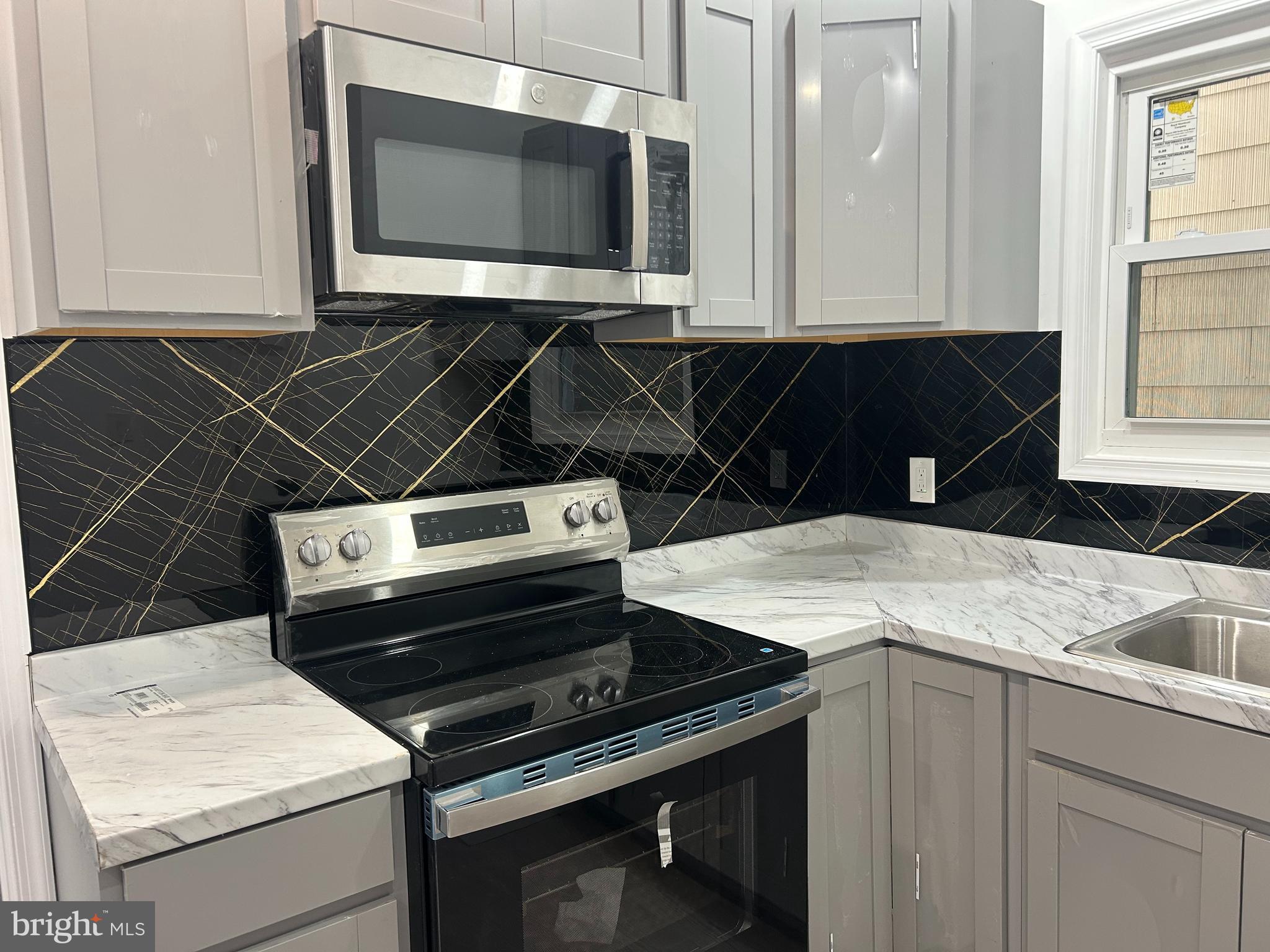 222 West Patterson Street, Unit 2 Lansford, PA 18232 - Photo 9 of 16 a close view of a stove a microwave and cabinets