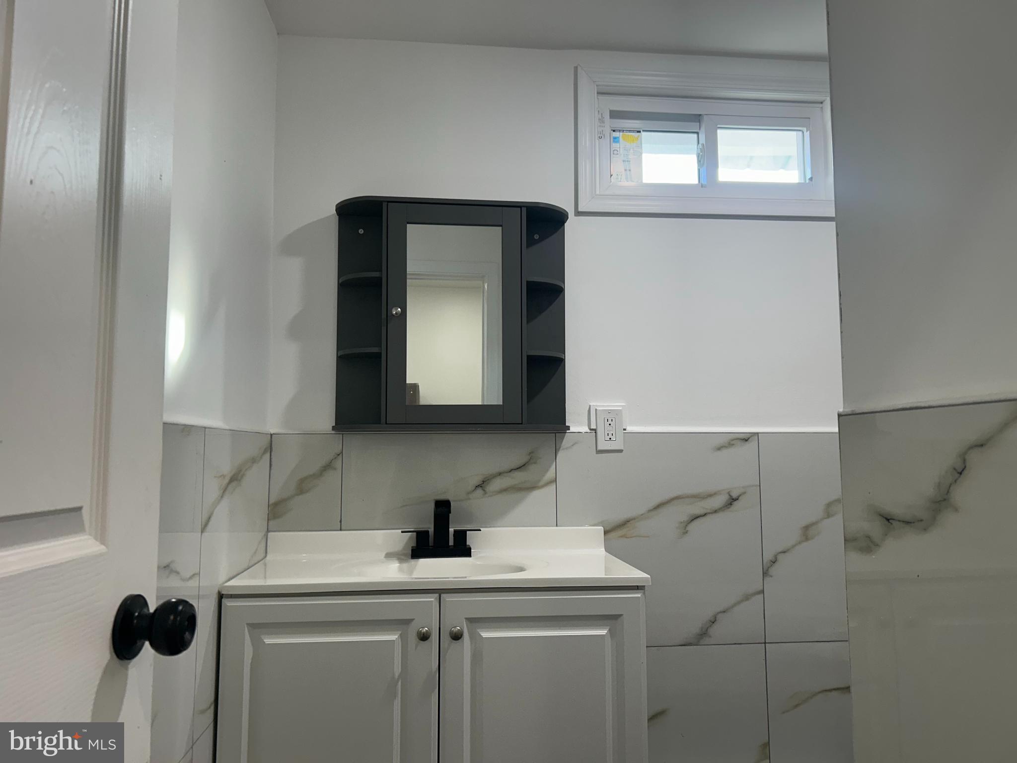 222 West Patterson Street, Unit 2 Lansford, PA 18232 - Photo 10 of 16 a bathroom with a sink a toilet and mirror