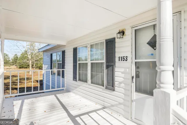 a view of a house with a yard covered in snow