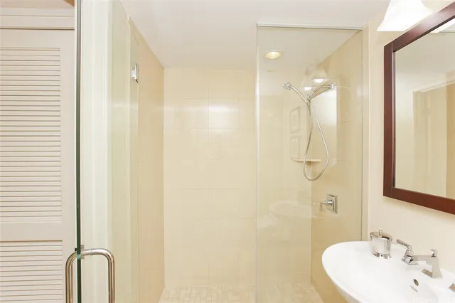 a bathroom with a shower and a sink