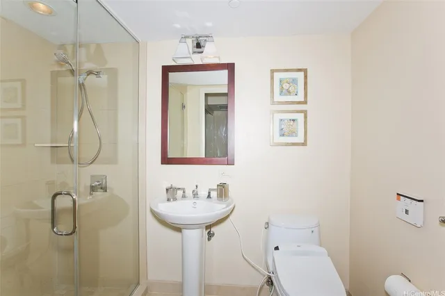 a bathroom with a sink shower and mirror