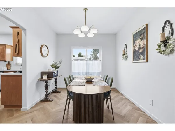 a view of a dining room with furniture and a chandelier fan