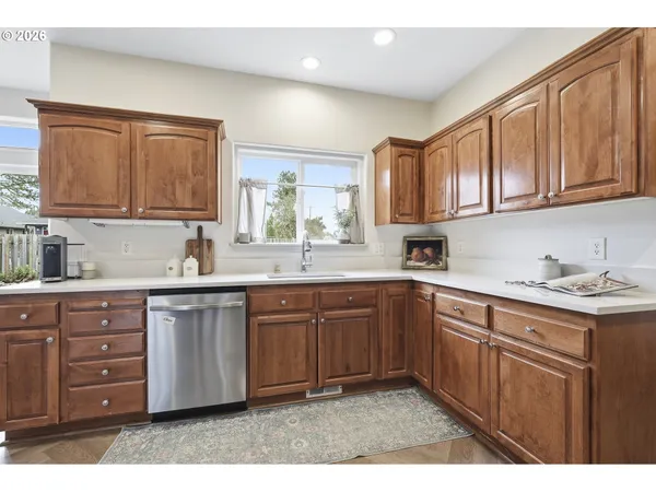 a kitchen with stainless steel appliances granite countertop a sink stove and cabinets